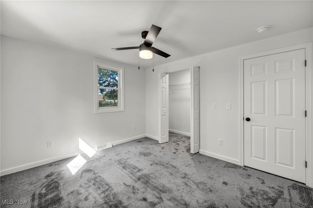 43575 Cream Ridge Road Lisbon, OH 44432 - Photo 28 of 50 Unfurnished bedroom with carpet flooring, ceiling fan, and a closet