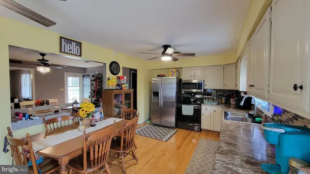 a living room with lots of furniture and kitchen view