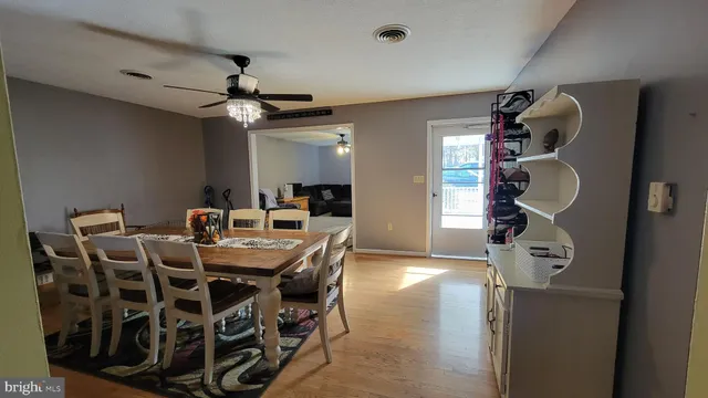 a view of a dining room with furniture and chandelier