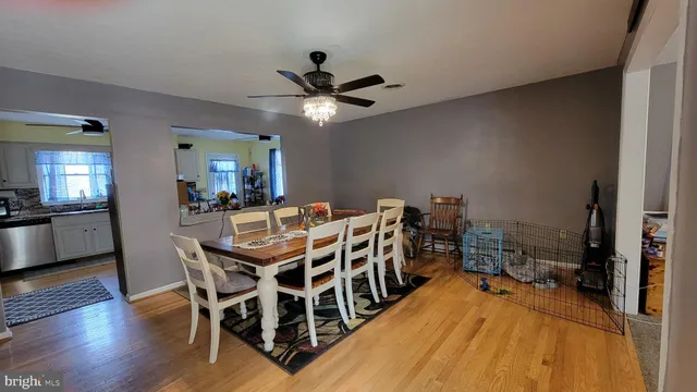 a view of a dining room with furniture and wooden floor