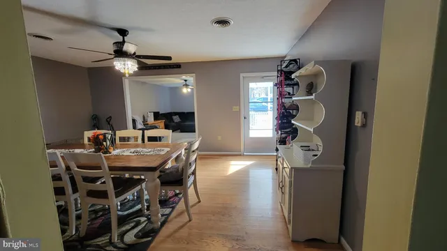 a dining room with furniture and a chandelier