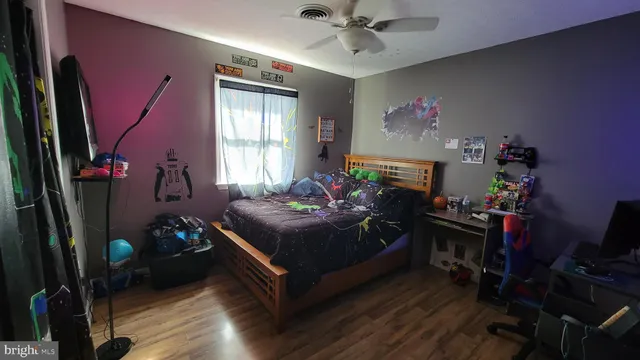 a bed room with a bed mirror and a window