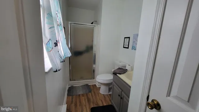 a bathroom with a toilet and a shower
