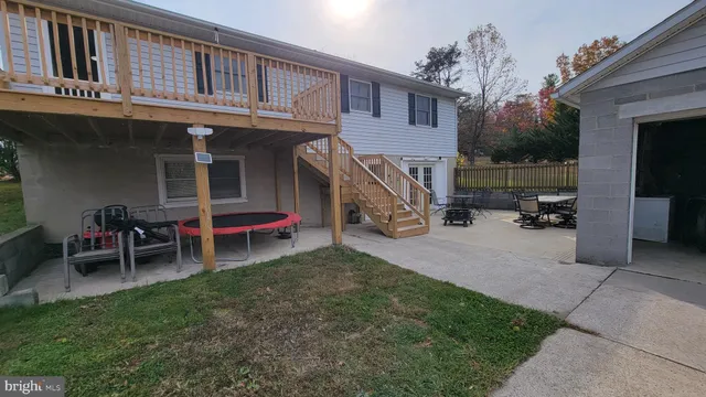 a view of a house with a yard and sitting area