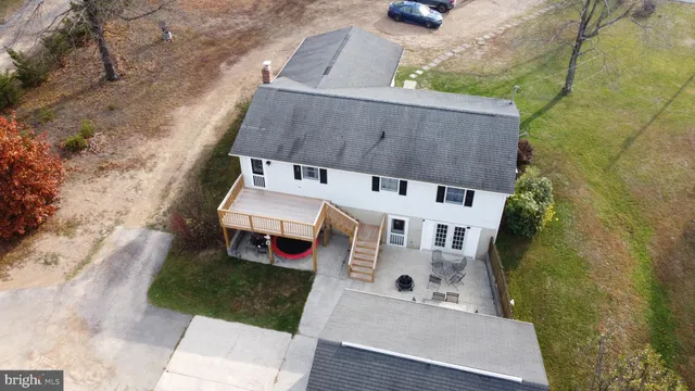 an aerial view of a house with outdoor space