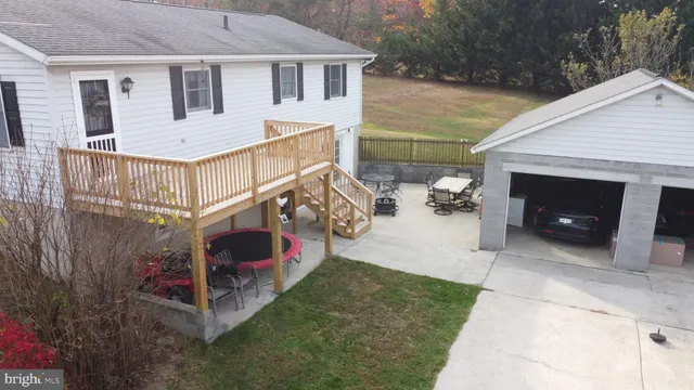 a view of a house with a yard and furniture
