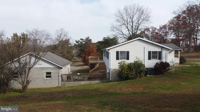 a view of backyard of house and garden