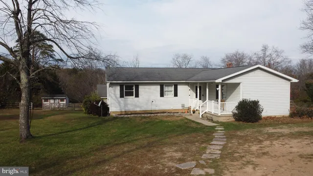a view of a house with a yard covered in snow