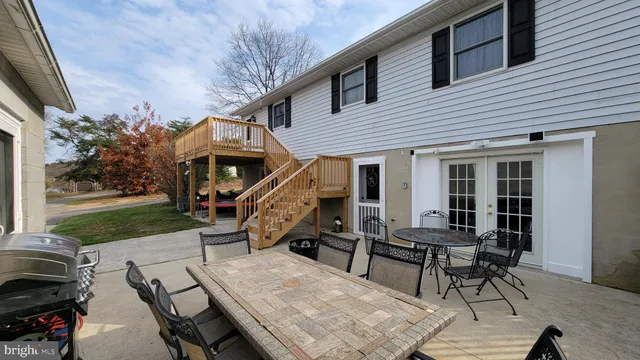 a view of a house with backyard sitting area and garden