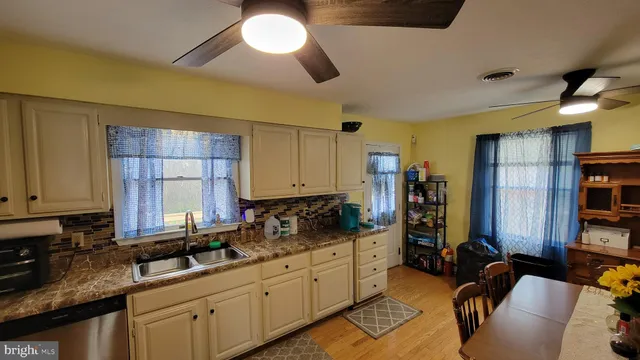 a kitchen with sink a stove and cabinets