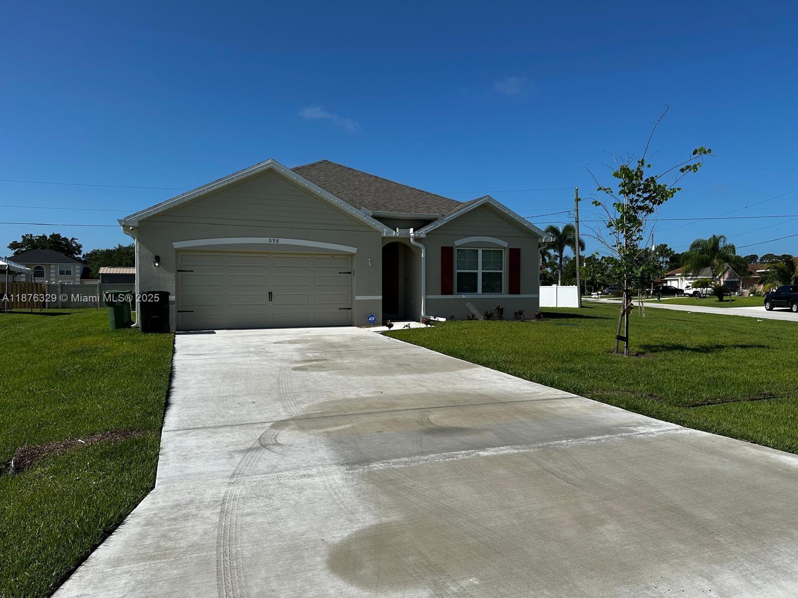 2098 Southwest Altman Avenue Port St. Lucie, FL 34953 - Photo 1 of 27 a front view of a house with a yard