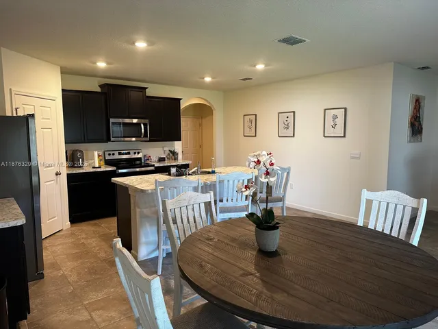 a kitchen with a dining table and chairs