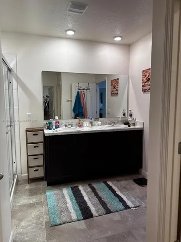 a living room with furniture and a mirror