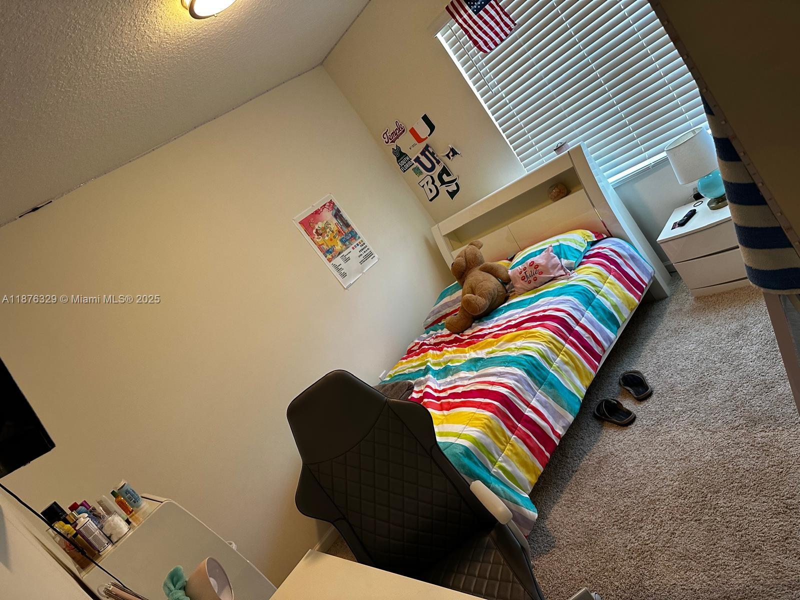 2098 Southwest Altman Avenue Port St. Lucie, FL 34953 - Photo 19 of 27 a bedroom with a bed and a couch