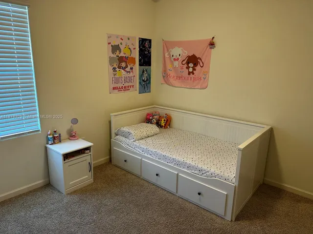 a spacious bedroom with a bed and a desk