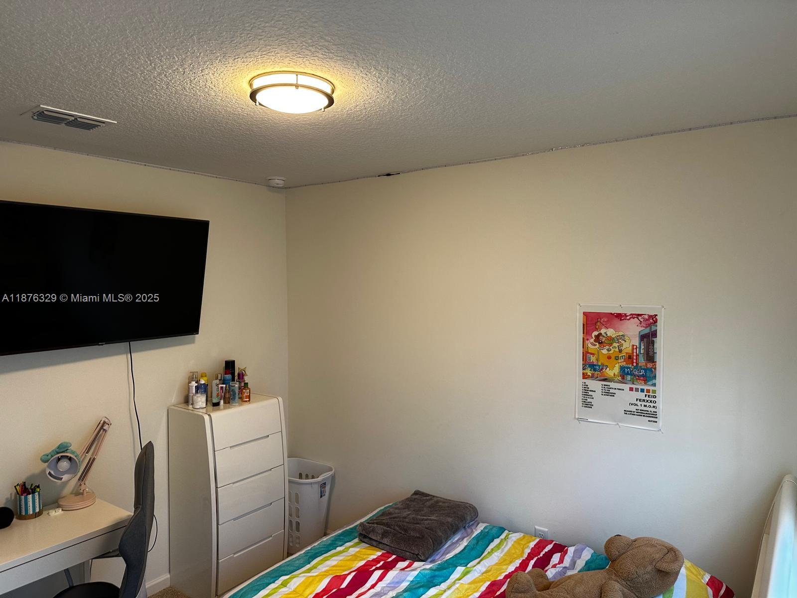 2098 Southwest Altman Avenue Port St. Lucie, FL 34953 - Photo 23 of 27 a room with furniture and a flat screen tv