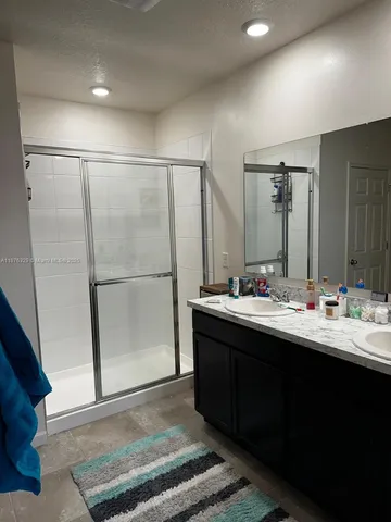 a bathroom with a double vanity sink and mirror