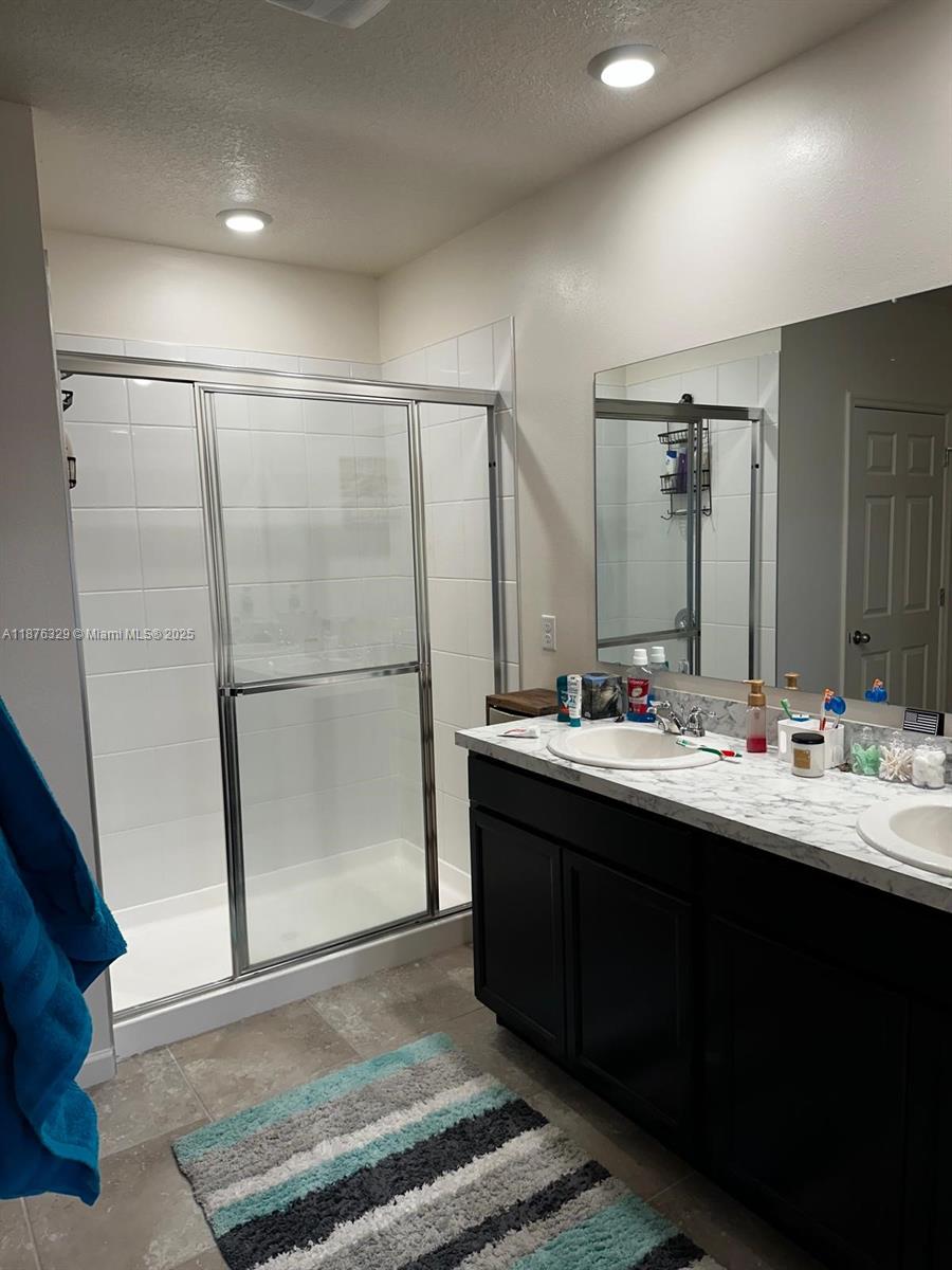 2098 Southwest Altman Avenue Port St. Lucie, FL 34953 - Photo 25 of 27 a bathroom with a double vanity sink and mirror