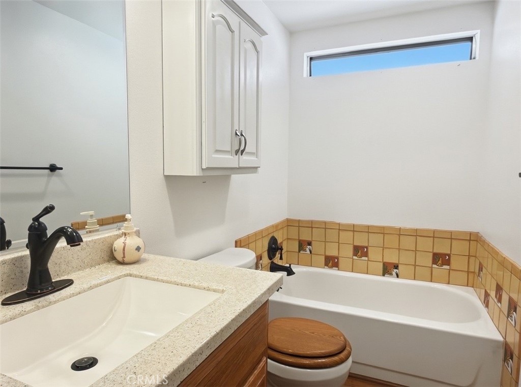 18070 Langlois Road Desert Hot Springs, CA 92241 - Photo 13 of 14 a bathroom with a tub sink and toilet