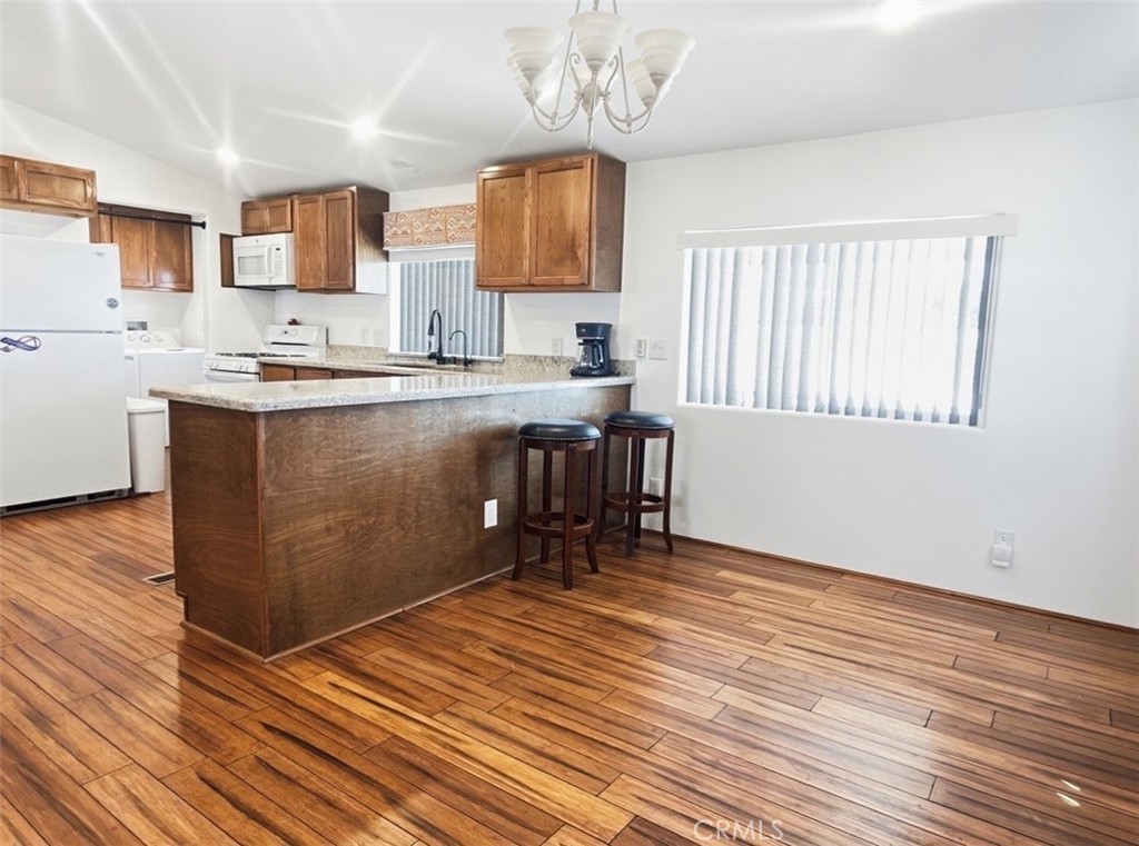 18070 Langlois Road Desert Hot Springs, CA 92241 - Photo 4 of 14 a kitchen with stainless steel appliances granite countertop a sink wooden cabinets and a granite counter tops