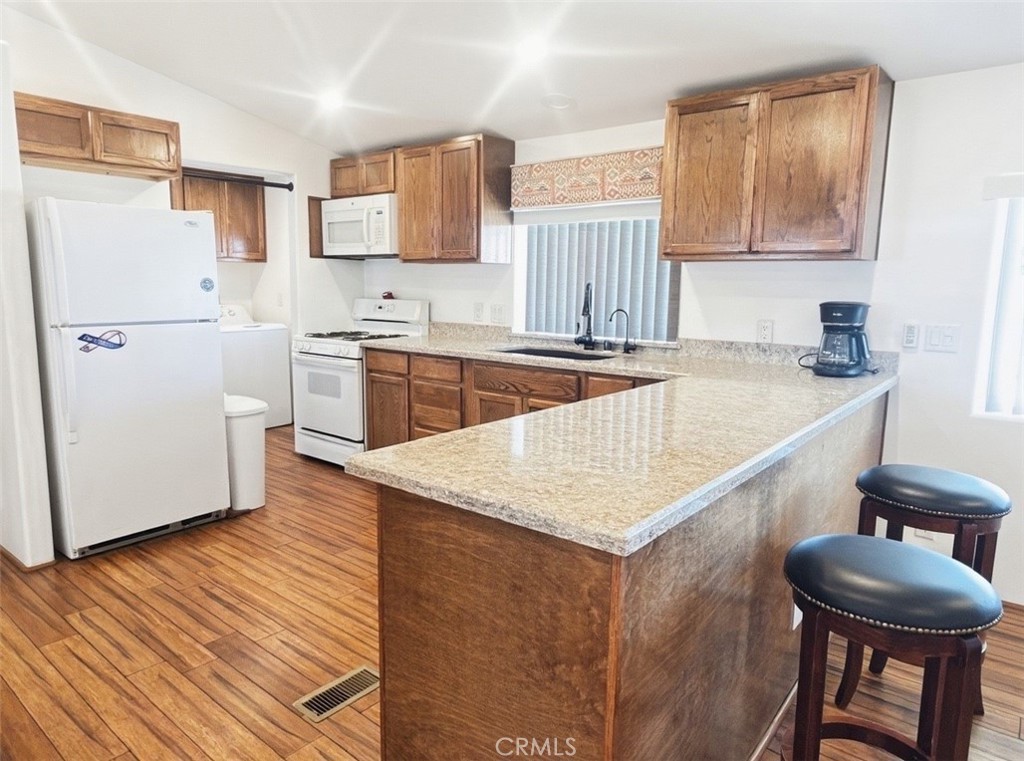 18070 Langlois Road Desert Hot Springs, CA 92241 - Photo 7 of 14 a kitchen with granite countertop a sink stove and refrigerator