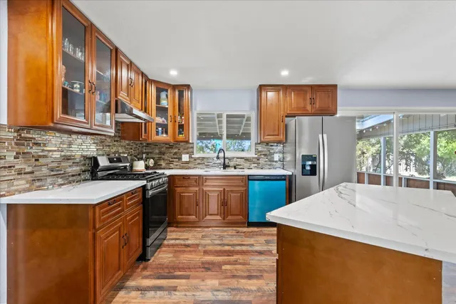 a stove top oven sitting inside of a kitchen