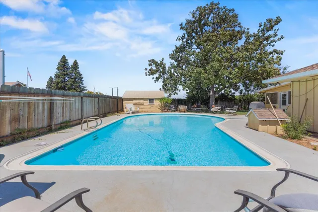 a view of a swimming pool with a patio