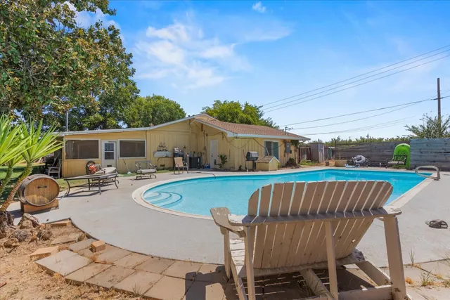 a backyard of a house with table and chairs