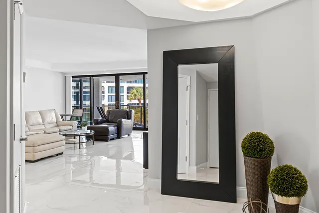 a living room with furniture and potted plant