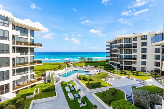 a view of a swimming pool with a table and chairs