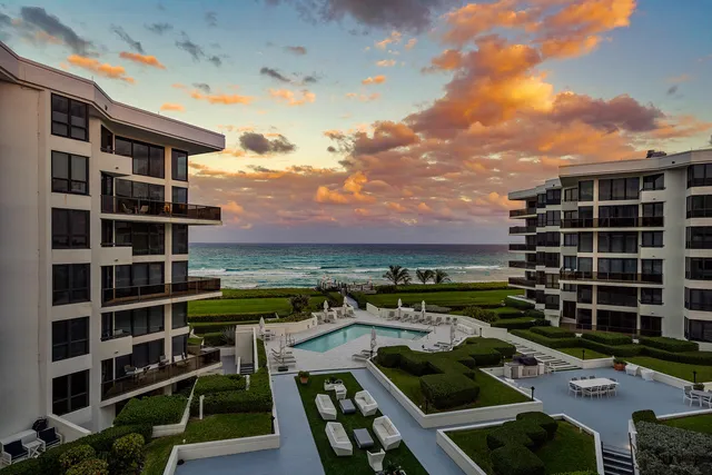 a view of a terrace with lawn chairs