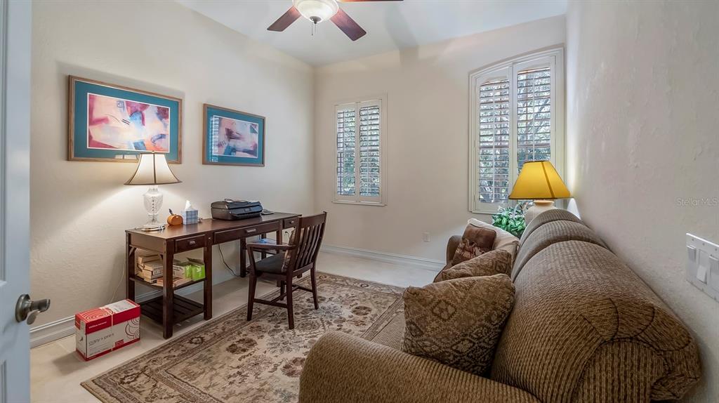 23 Camino Real, Unit 23 Howey-in-the-Hills, FL 34737 - Photo 25 of 46 a living room with furniture and a lamp