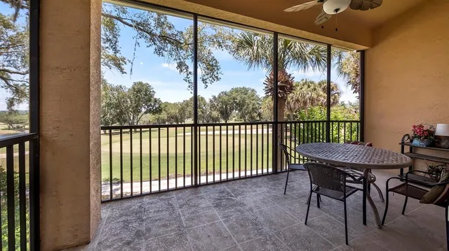 a view of a porch with a table and chairs