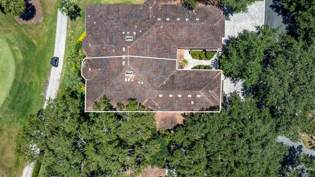an aerial view of a house by greenery space