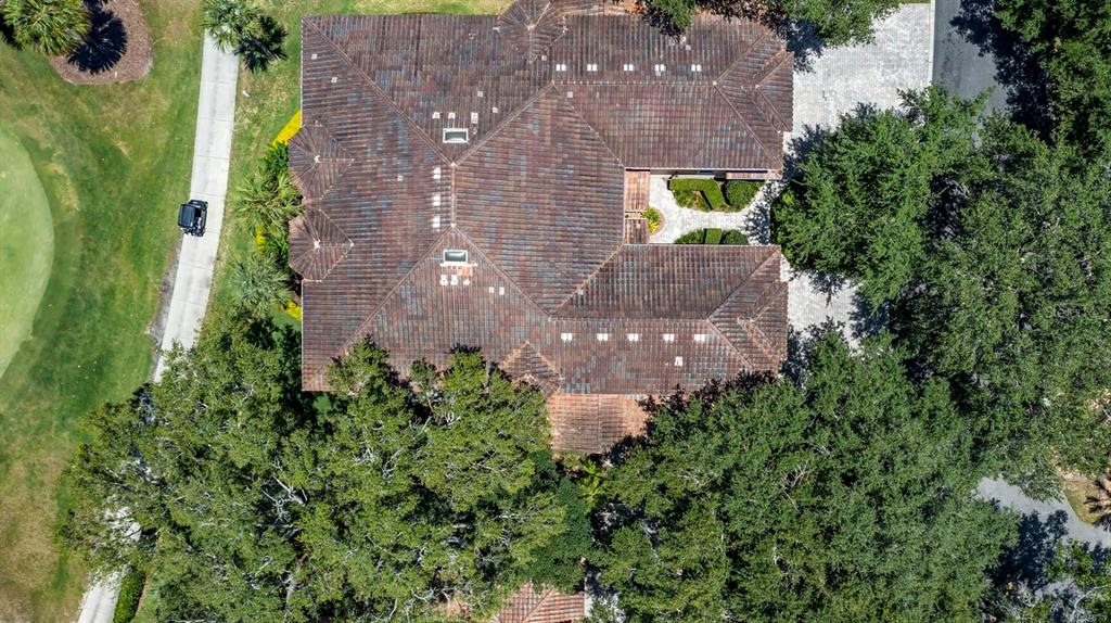 23 Camino Real, Unit 23 Howey-in-the-Hills, FL 34737 - Photo 41 of 46 an aerial view of a house by greenery space