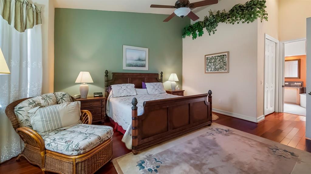 23 Camino Real, Unit 23 Howey-in-the-Hills, FL 34737 - Photo 5 of 46 a bedroom with a bed and a chandelier