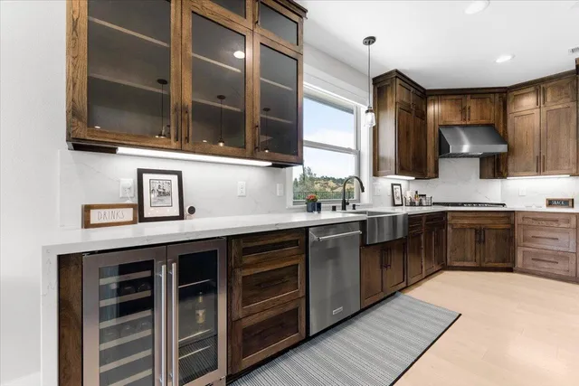 a kitchen with stainless steel appliances kitchen island granite countertop a sink and cabinets
