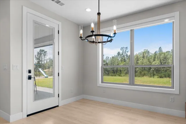 a view of a hallway with a chandelier