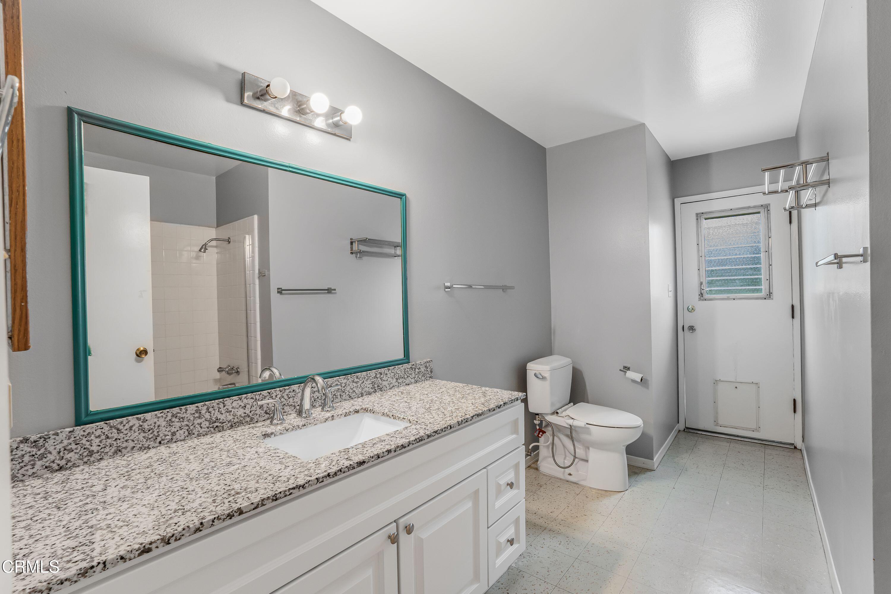 1738 Abbott Avenue Camarillo, CA 93010 - Photo 21 of 36 a bathroom with a granite countertop sink toilet and shower
