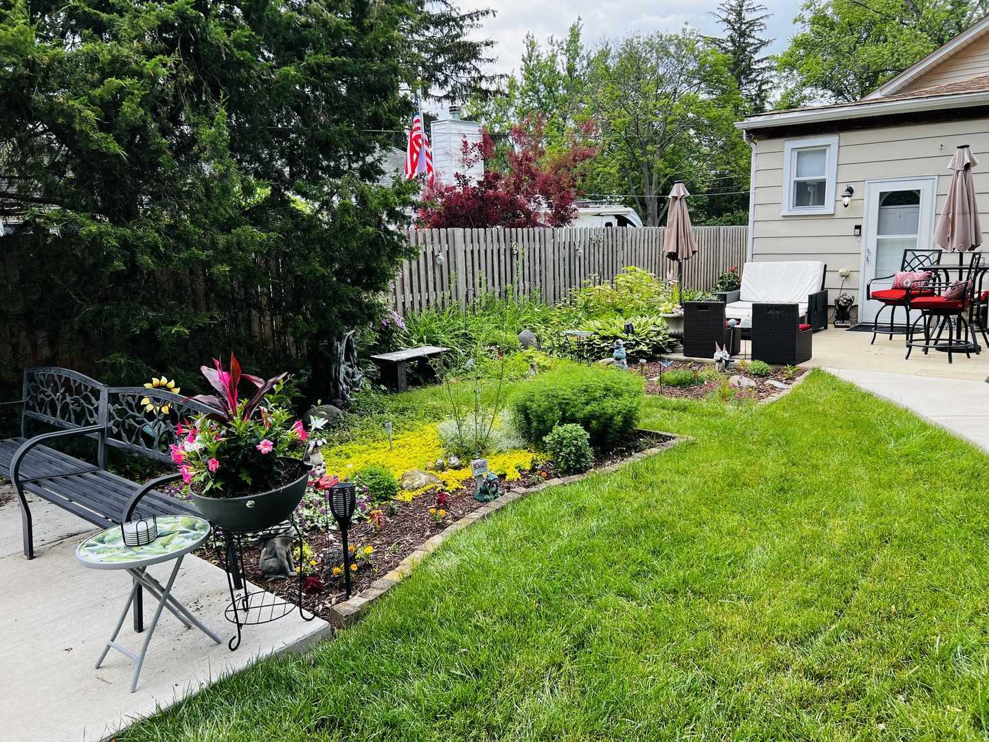 205 West Harrison Road Lombard, IL 60148 - Photo 11 of 26 a view of a house with backyard sitting area and garden