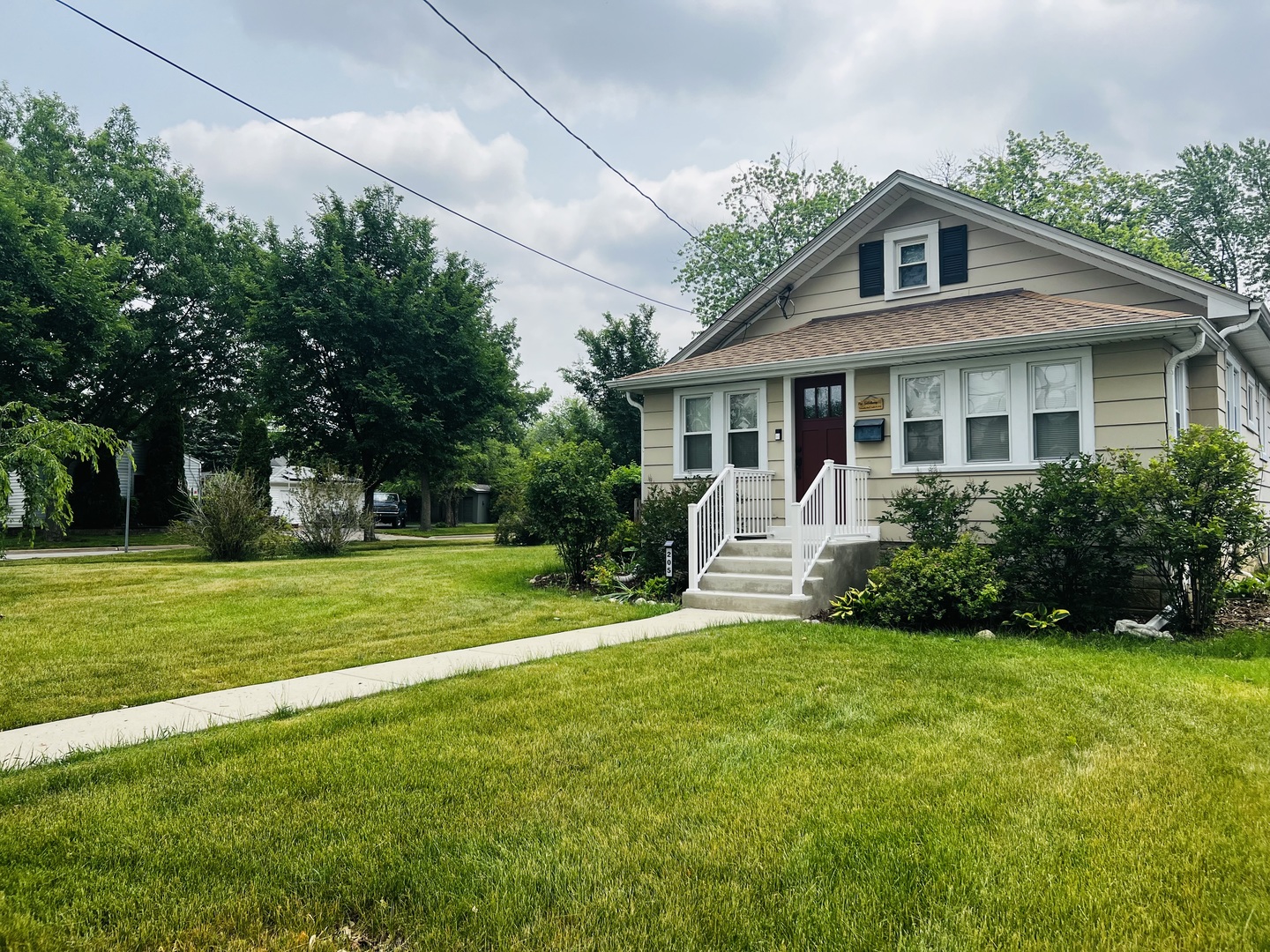 205 West Harrison Road Lombard, IL 60148 - Photo 2 of 26 a front view of a house with a yard table and chairs
