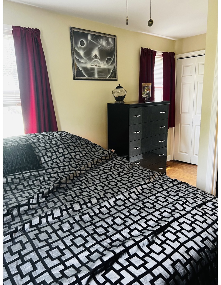 205 West Harrison Road Lombard, IL 60148 - Photo 22 of 26 a bedroom with a bed and wooden floor