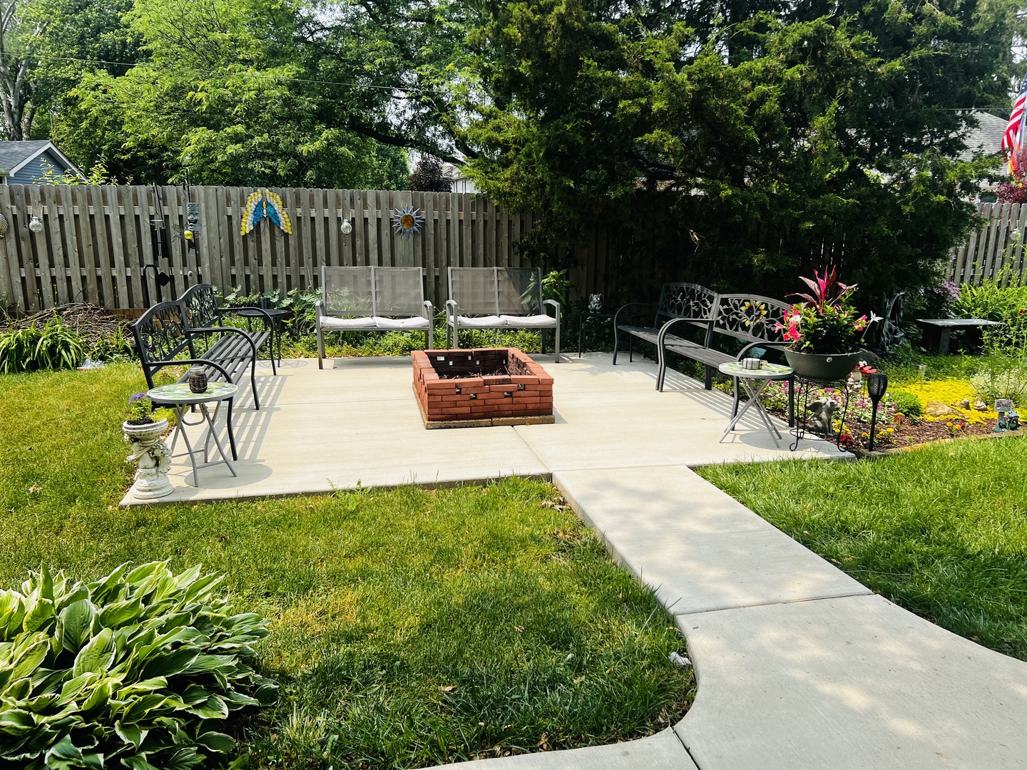 205 West Harrison Road Lombard, IL 60148 - Photo 8 of 26 a view of a backyard with plants and a garden