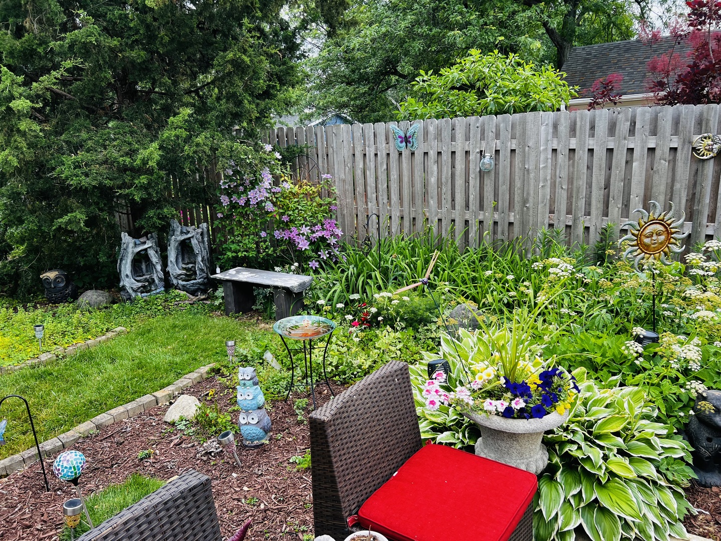 205 West Harrison Road Lombard, IL 60148 - Photo 10 of 26 a view of a backyard with potted plants and a bench