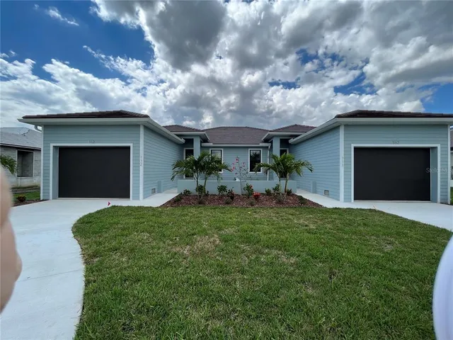 a front view of a house with a yard and garage