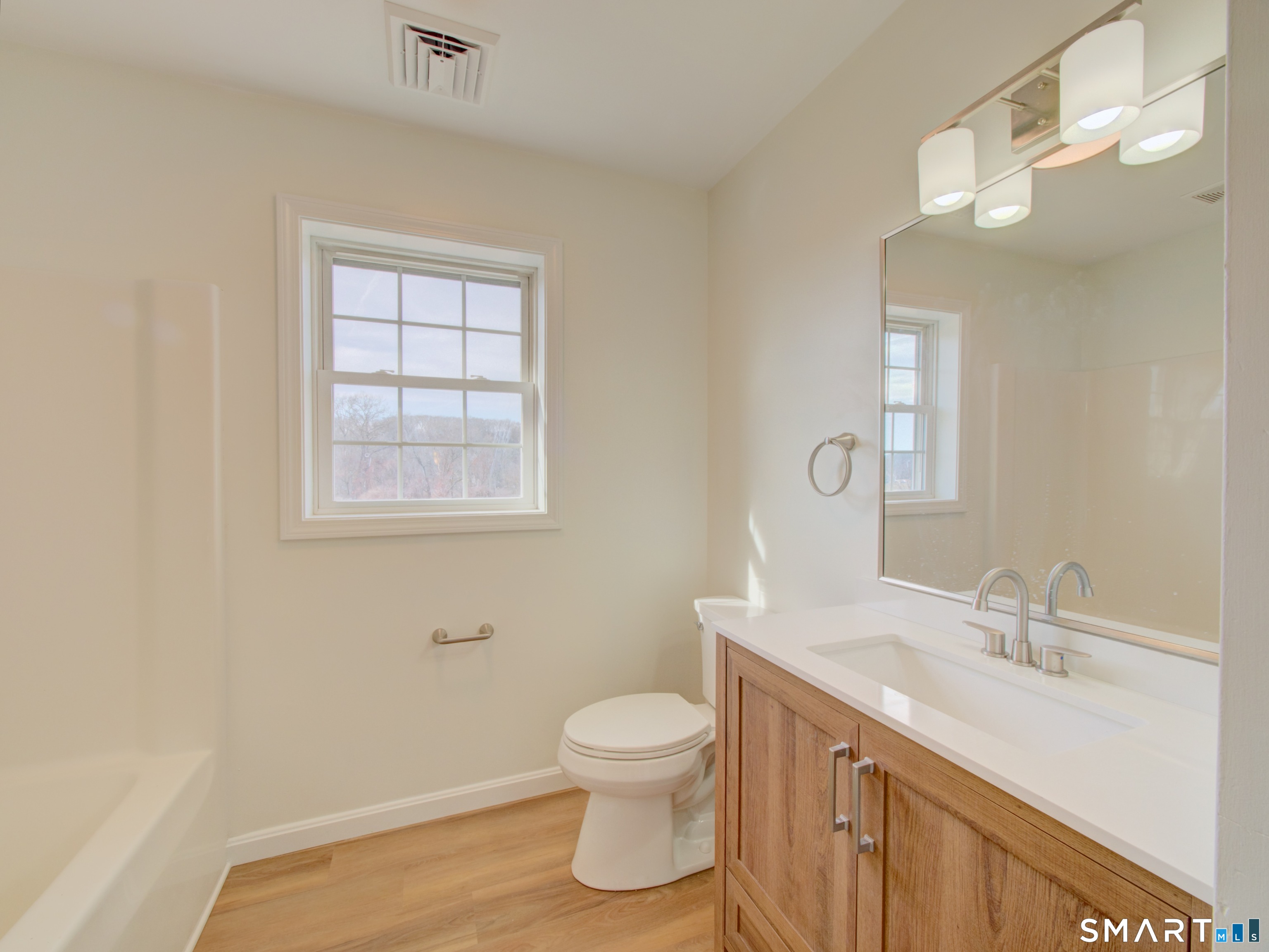 55 Tuckie Road Windham, CT 06280 - Photo 12 of 17 a bathroom with a toilet a sink a mirror and a window