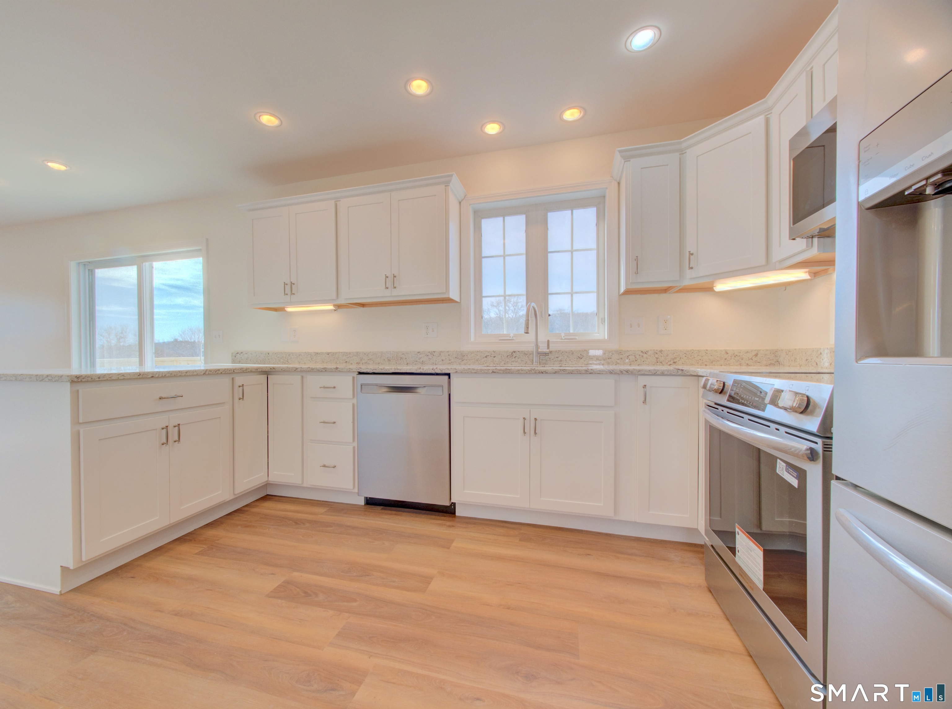 55 Tuckie Road Windham, CT 06280 - Photo 2 of 17 a kitchen with white cabinets appliances a sink and a window
