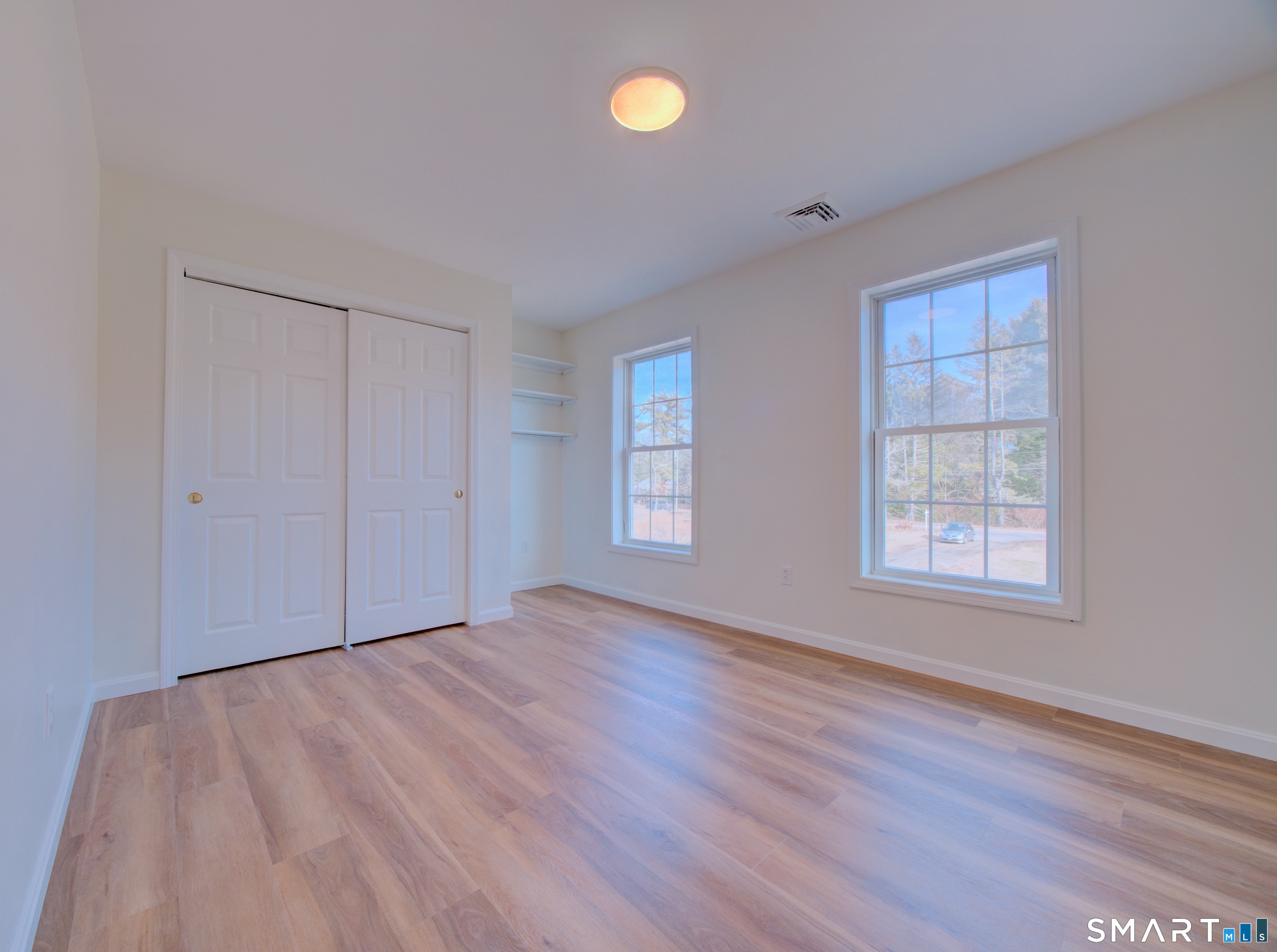 55 Tuckie Road Windham, CT 06280 - Photo 10 of 17 a view of an empty room with window and wooden floor