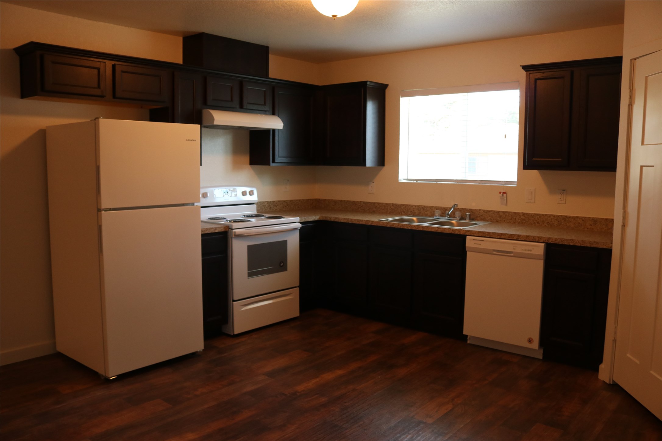 10535 Mills Road, Unit 9C Houston, TX 77070 - Photo 30 of 48 a kitchen with stainless steel appliances a sink a stove a refrigerator and cabinets