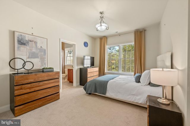 a spacious bedroom with a bed and a couch